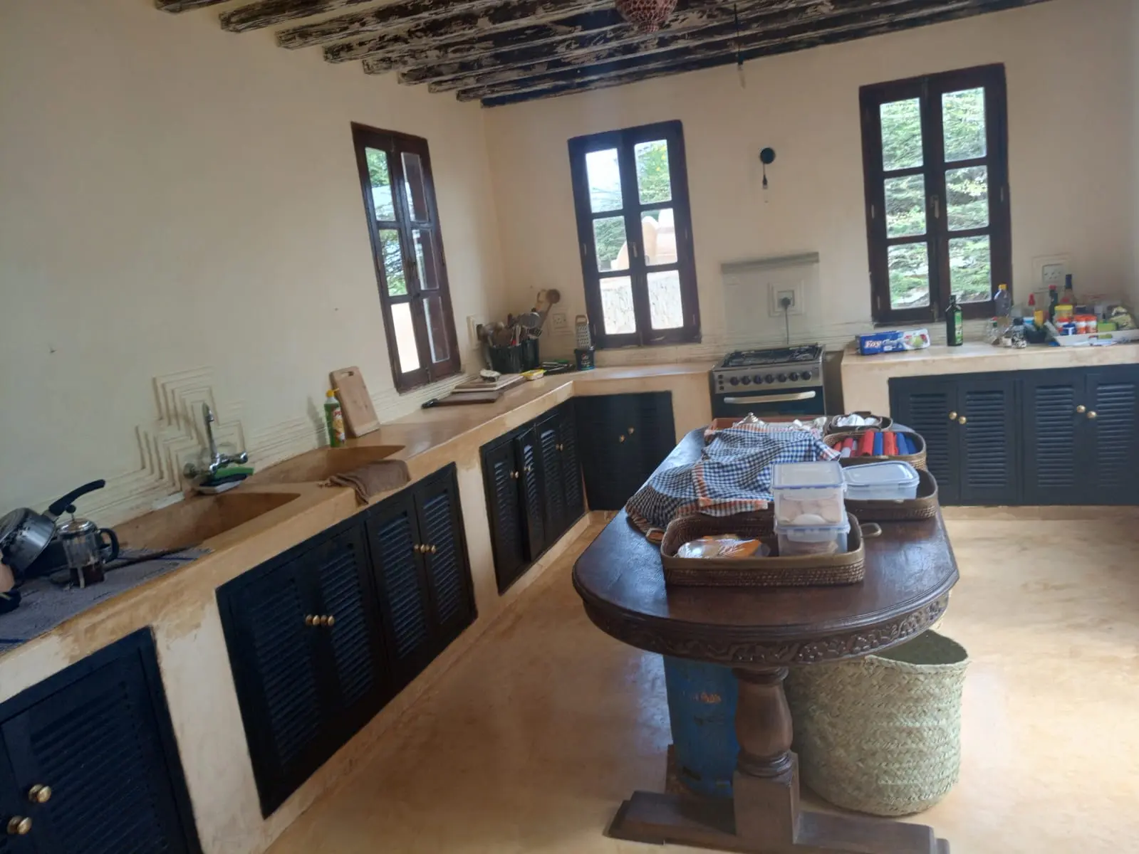 Traditional kitchen with wooden countertops and blue shuttered cabinets in Main House