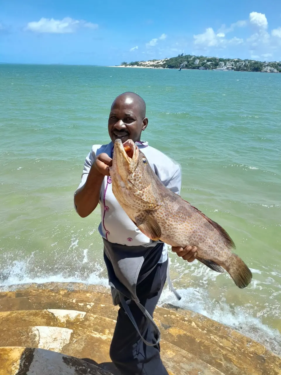 Chef with fresh caught fish on the beach