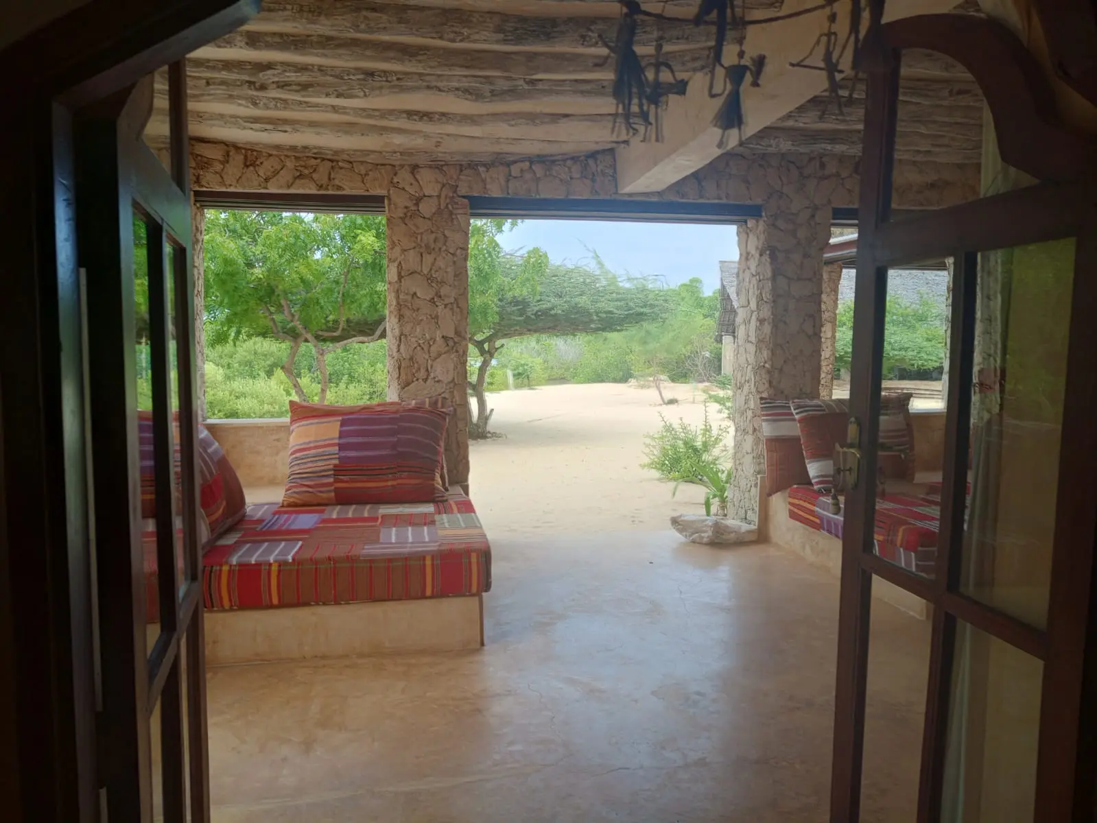 View through arched doorways to terrace with garden and courtyard views