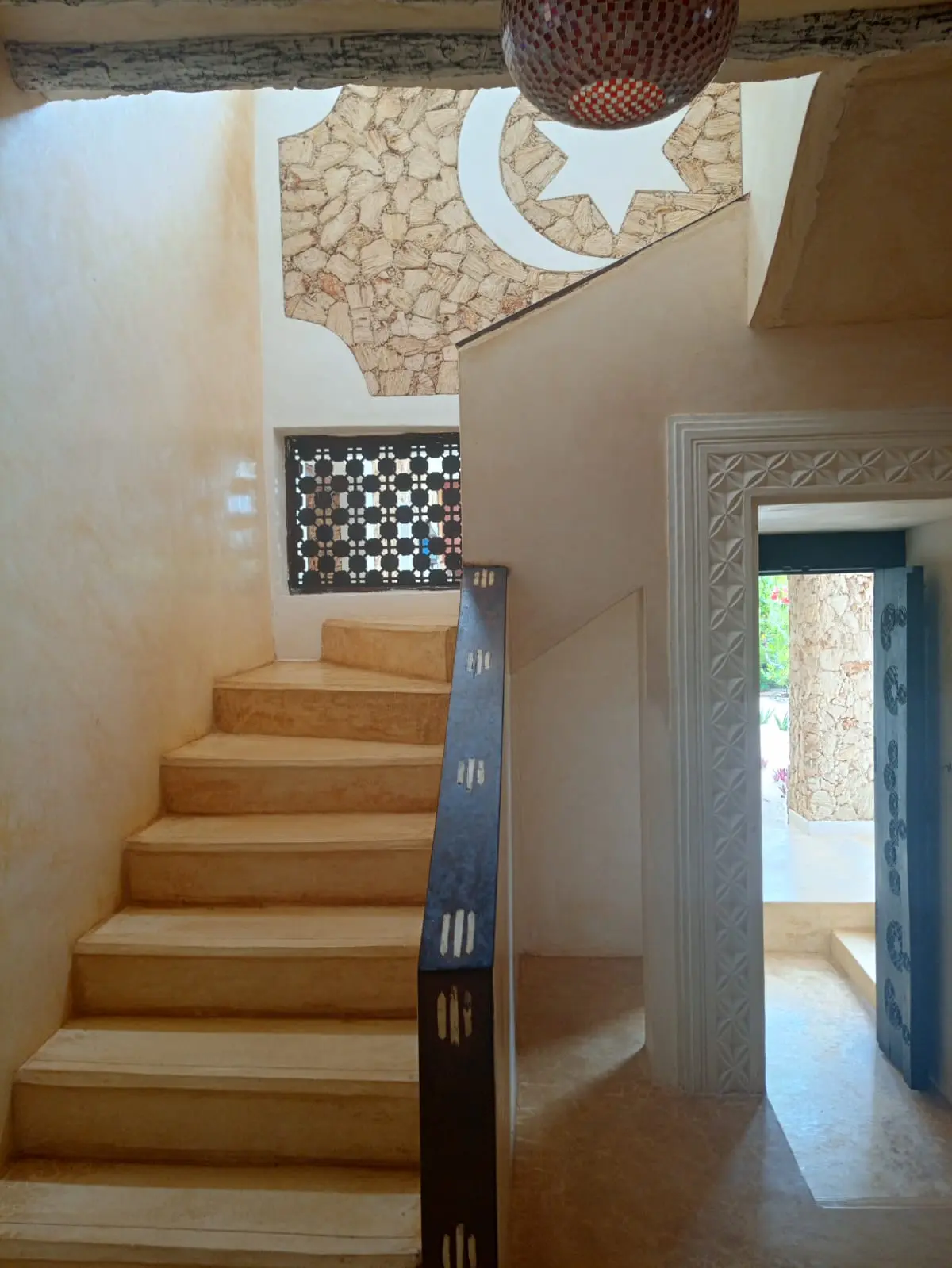 Beautiful Swahili staircase with coral stone walls and geometric patterns